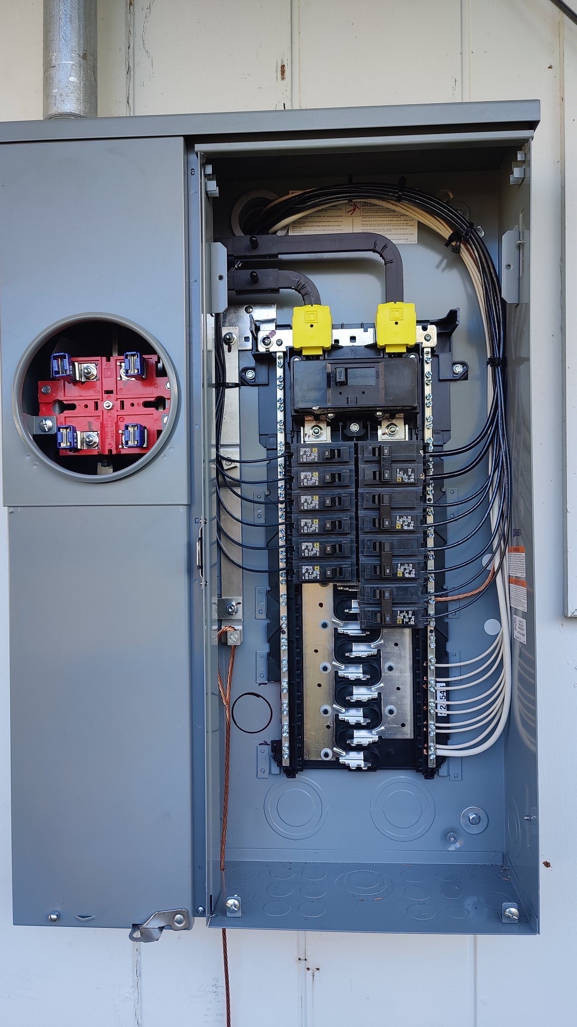 New 200-amp meter main panel with branch circuits re-terminated and labeled